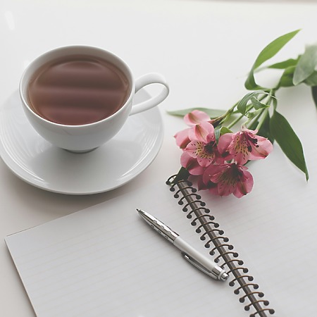 Coffee cup and flowers